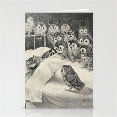 An Owl And Her Kittens Are On The Bed With Their Eyes Open Looking At