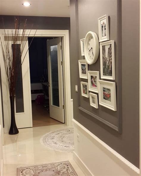 A Hallway With Pictures On The Wall And A Clock Hanging On The Wall