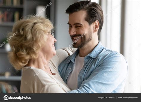 Close Up Smiling Mature Mother And Adult Son Hugging Stock Photo Fizkes 407448220