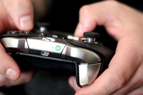Premium Photo Midsection Of Person Holding Game Controller