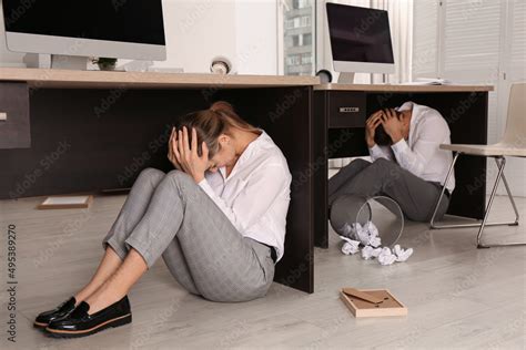 Scared Employees Hiding Under Office Desks During Earthquake Stock