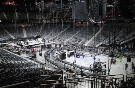 the inside of an arena with people standing around and playing hockey on ice rinks