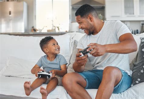 One More Time A Young Man Playing Video Games With His Son At Home