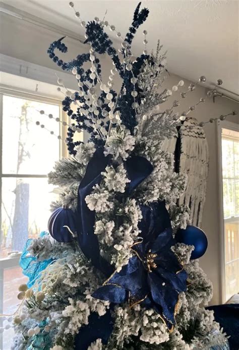 Elegant Flocked Christmas Tree With Blue And Silver Decorations