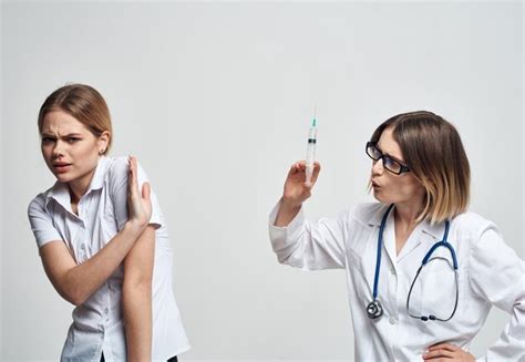 Premium Photo A Woman Holds A Syringe In Her Hand And A Female