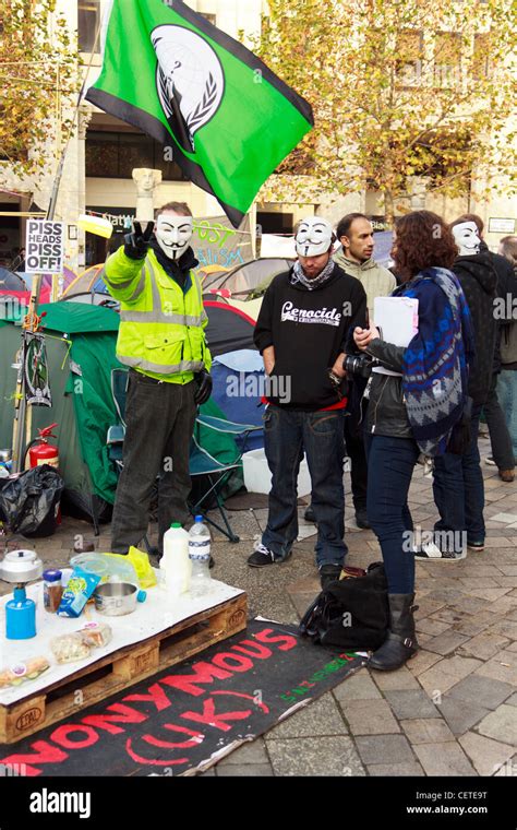 An Occupy London Protester Show Peace Sign While Standing With Other