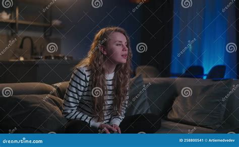 Cute Blonde Curly Woman Switching On Television Navigating In Smart Tv Applications While