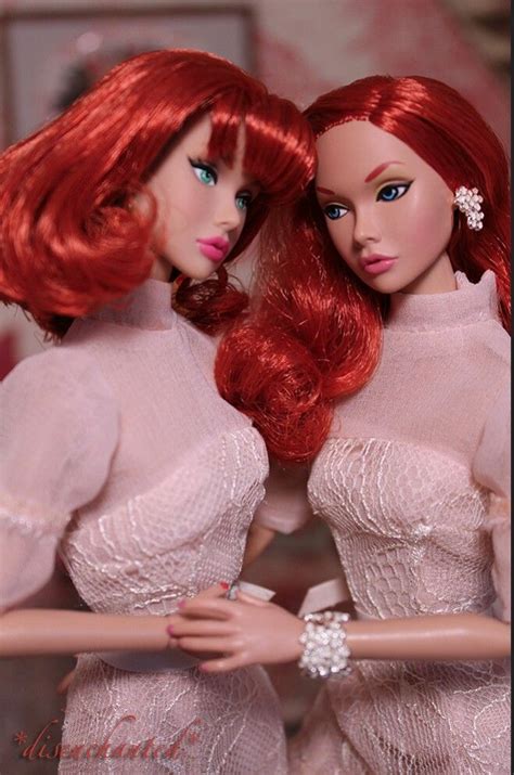 Two Red Haired Dolls Are Standing Next To Each Other With Their Hands