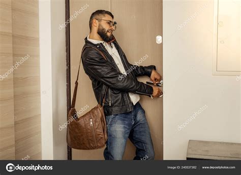 Handsome Tall Short Haired Bearded Man With A Bag Closing The Door