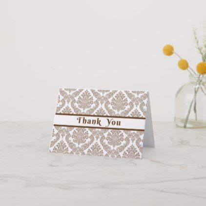 A Thank You Card Sitting On Top Of A Table Next To A Vase With Flowers