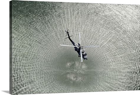 An MH 60R Sea Hawk Helicopter Hovers Above The Pacific Ocean Wall Art