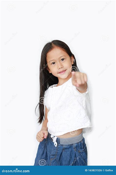 Cheerful Little Asian Girl Child Pointing At You And Looking Camera