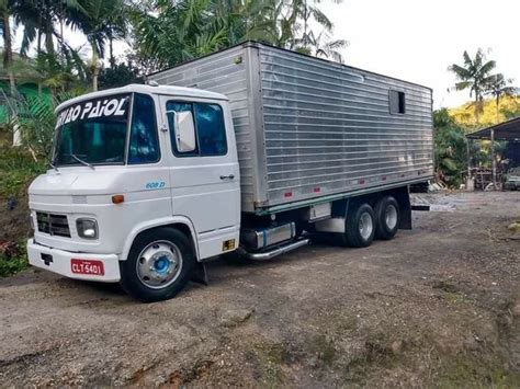 A White Truck Is Parked In Front Of Some Palm Trees