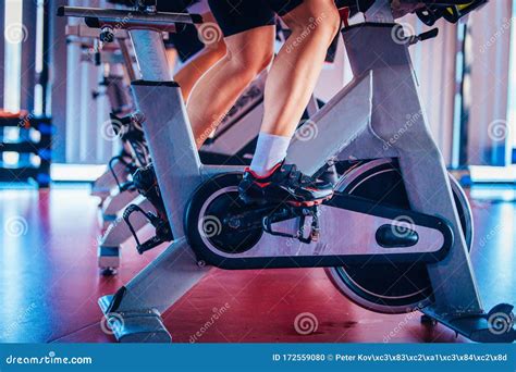 Spinning Class Group Activity On Stationary Bike Team Cardio