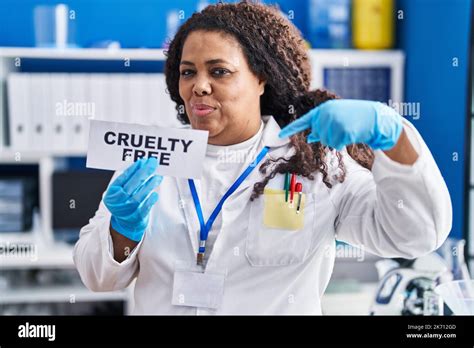 Plus Size Hispanic Woman Working On Cruelty Free Laboratory Pointing