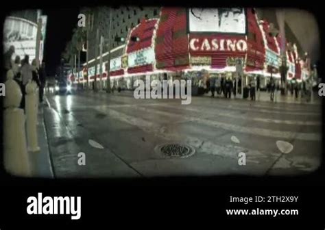 Wide Angle Shot Of Black Expensive Car As It Drives Down A Crowded Busy Strip In Old Downtown