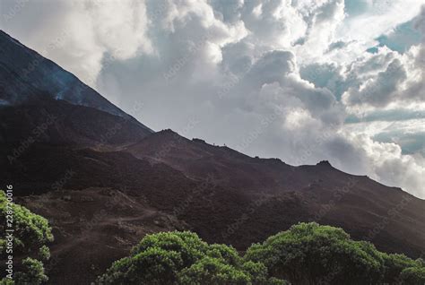 Tourists hike the changing landscapes around the Volcan Pacaya, one of ...