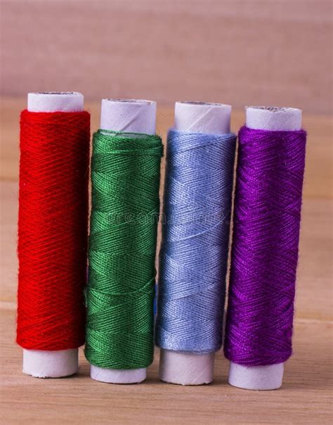 Multi Colored Large Spools Of Thread In A Row Spools Of Colored Thread