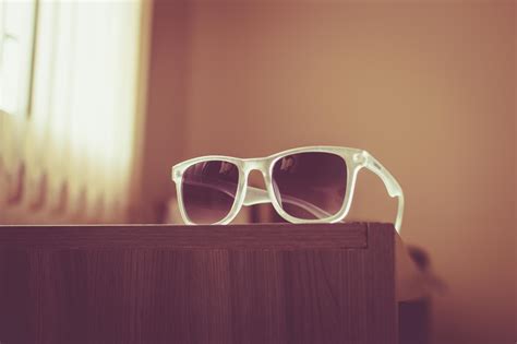 Neo Chrome Sunglasses With Silver And Black Frame On Brown Firewood