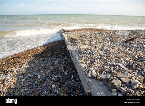 Longshore Drift Illustrated By Sediment Either Side Of Wooden Groyne On