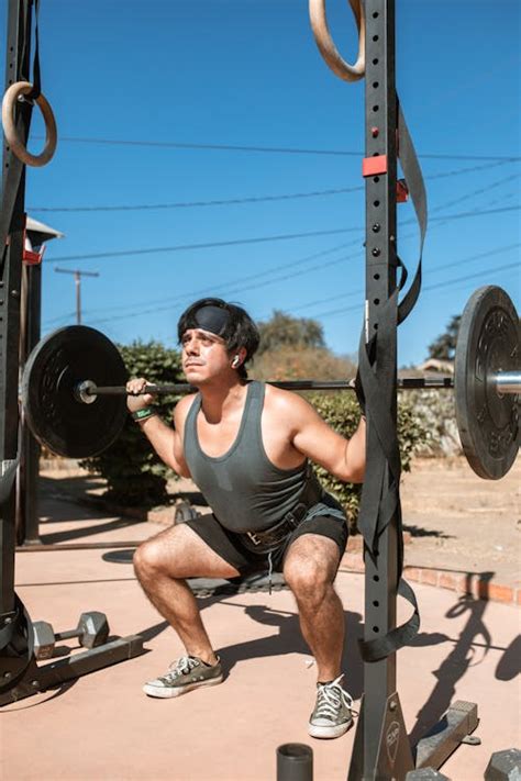 Photo Of Man Holding Barbell · Free Stock Photo