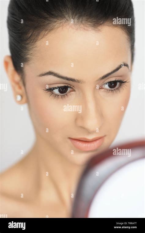 Indian Young Woman Looking Into A Mirror Stock Photo Alamy