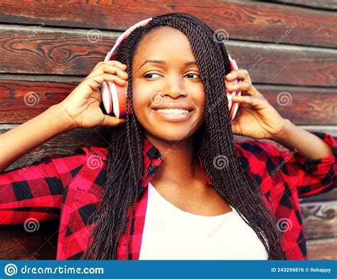 Portrait Of Happy Smiling African Woman Listening To Music In