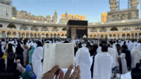 A pilgrim holds a small notebook with a heart doodle in front of the