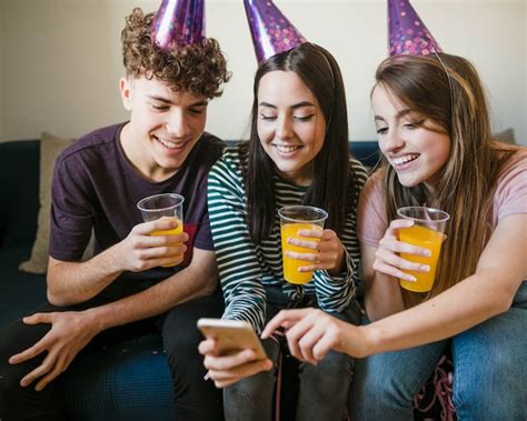 Free Photo | Happy friends holding cups of juice