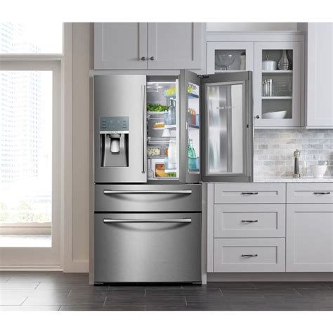 A Stainless Steel Refrigerator And Freezer Combo In A Kitchen With