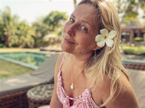 Portrait Of A Beautiful Middle Aged Blonde Woman With A Frangipani Flower Stock Photo Image Of