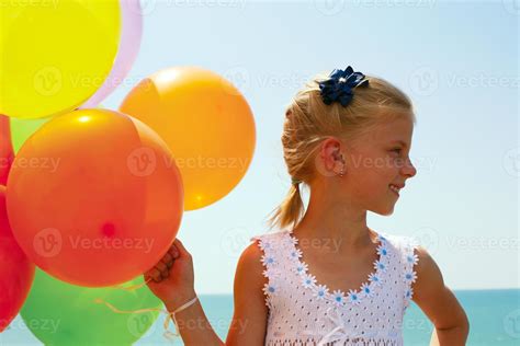 Smiling girl with balloons 1394325 Stock Photo at Vecteezy