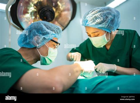 Asian Professional Surgeons Team Performing Surgery In The Operating