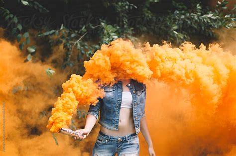 Young woman with orange smoke bomb at the nature . by Alexey Kuzma ...