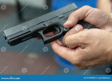 A Hand Of Man Practicing Firing Using A Glock Gun Model At The Shooting