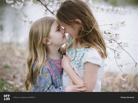 Two Young Girls Hugging Outside Near Pond Stock Photo Offset