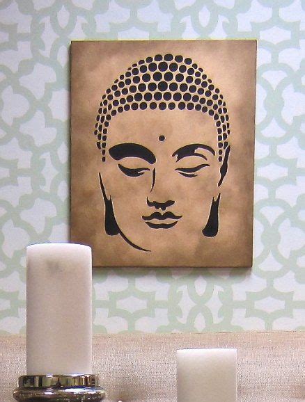 A Buddha Statue Sitting On Top Of A Table Next To Two Candles And A