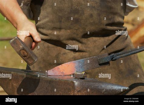 Hammering Glowing Steel To Strike While The Iron Is Hot Stock Photo Alamy