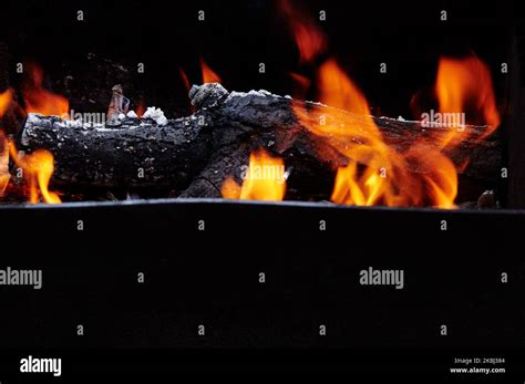 Burning Red Hot Sparks Fly From Fire Barbecue Gril With Glowing And Flaming Hot Charcoal And