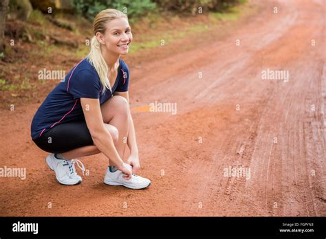 Smiling Athletic Blonde Tying Her Shoelace Stock Photo Alamy