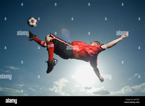 Low Angle View Of Soccer Player Jumping Stock Photo Alamy