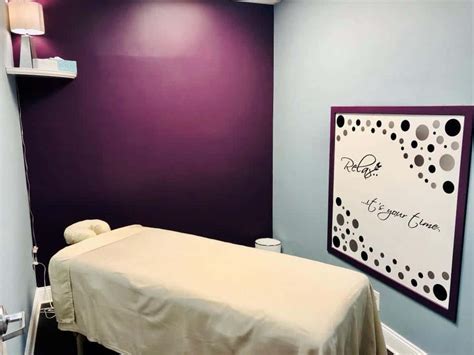 Download A Massage Room With Purple Walls And A Sign