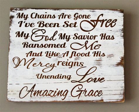 A Wooden Sign With Words Written On It That Says My Chains Are Gone I