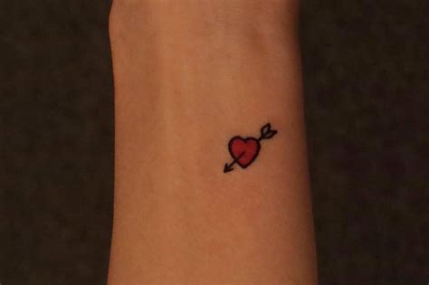 Minimalist Heart And Arrow Tattoo On The Wrist