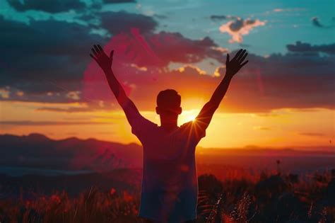 Premium Photo Silhouette Of A Man With Hands Raised In The Sunset