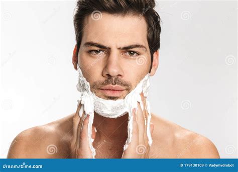 Photo Of Brutal Half Naked Man Applying Shaving Foam On His Face Stock