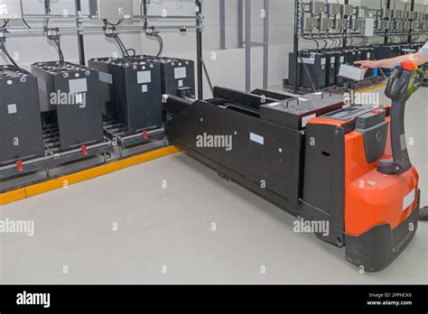 Pallet Jack Battery Cart at Industrial Charging Station Stock Photo - Alamy