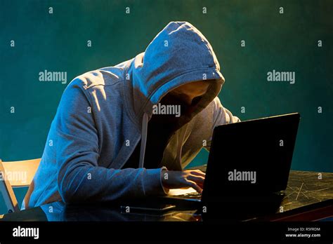 Hooded Computer Hacker Stealing Information With Laptop Stock Photo Alamy