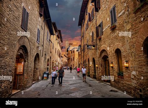 San Gimignano, Tuscany / Italy - 09.15.2017: Old cozy street in old town of San Gimignano an ...