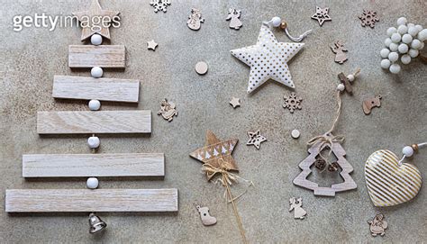 Wooden Christmas Tree And Christmas Toys On Light Stone Background